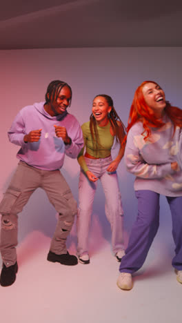 Vertical-Video-Studio-Shot-Of-Vertical-Video-Of-Group-Of-Gen-Z-Friends-Dancing-And-Having-Fun-Against-Pink-Background-1
